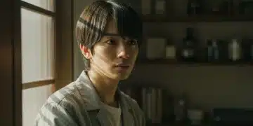 Evocative natural lighting in a Japanese drama scene, highlighting a character's introspection.
